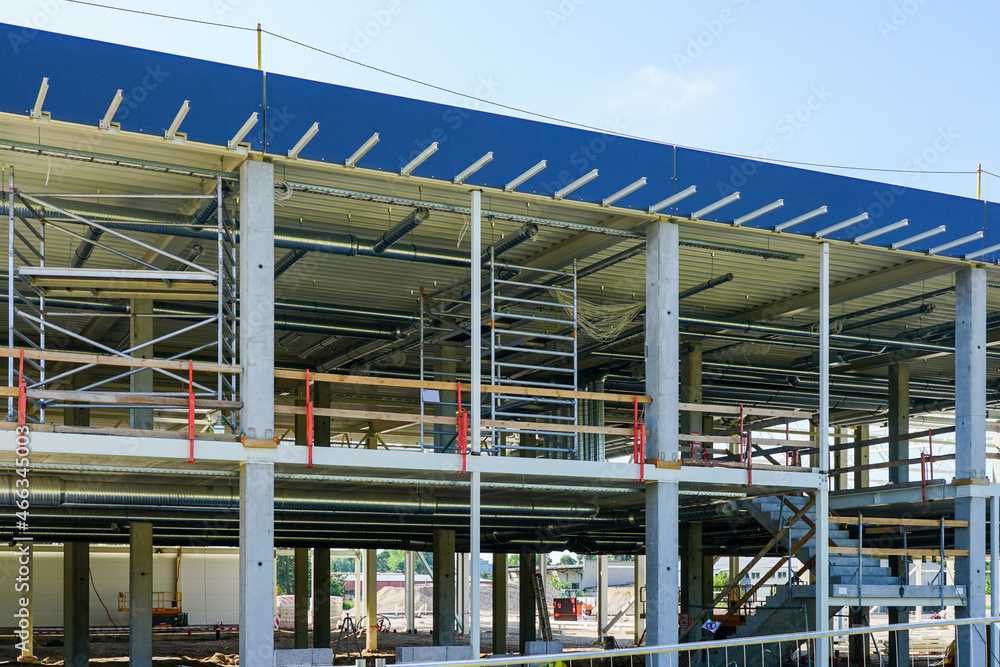 unfinished metal frame of a new modern industrial building with utilities