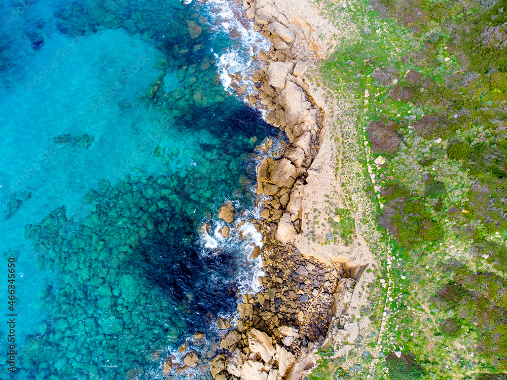 Green plants, rocks and blue sea in Alghero shore seen from above Green plants, rocks and blue sea in Alghero shore seen from above