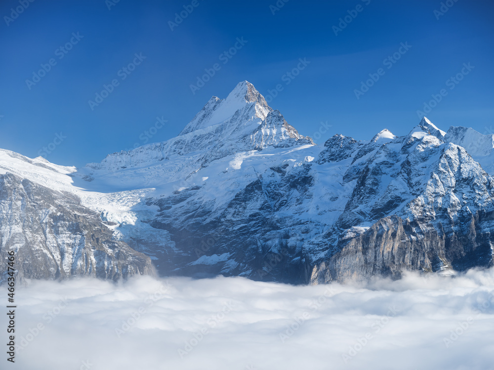 Mountains peaks and clouds in the valley. Natural landscape. Mountain range through the clouds. Landscape in the summertime. Large resolution photo.