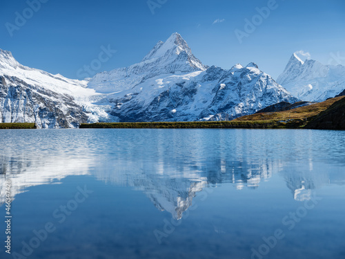 Fototapeta Naklejka Na Ścianę i Meble -  High mountains and reflection on the surface of the lake. Mountain valley with lake. Landscape in the highlands in the summertime. Photo in high resolution..