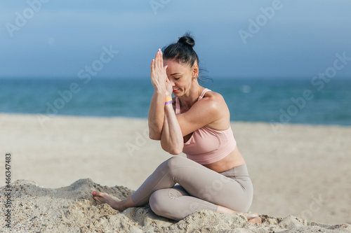 woman do yoga on the sea beach