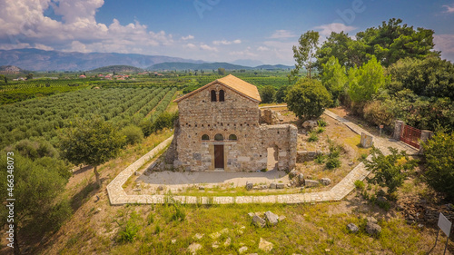 Aerial drone photo of ancient Vyzantine church of Agios Ioannis Riganas on top of hill at West Greece