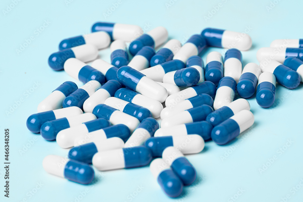 White and blue capsules on a light background White and blue capsules on a light background
