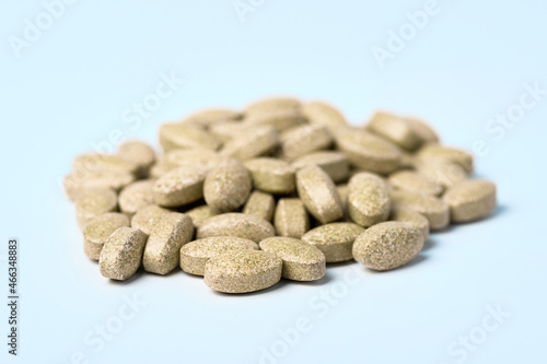 Daily vitamins on a light background. Light brown pills
