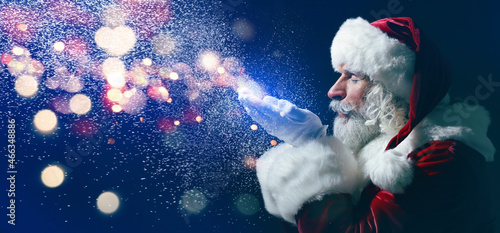 Portrait of Santa Claus playing with snow on dark background with space for text © Pixel-Shot