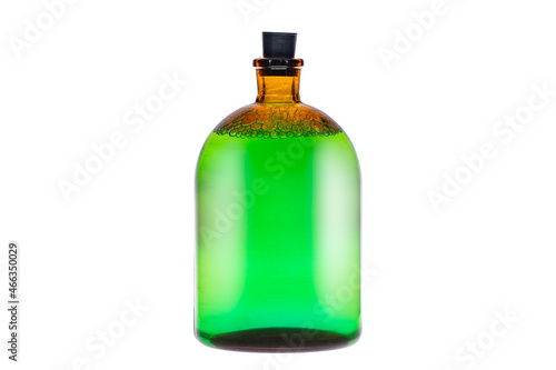 Green potion with bubbles in the yellow glass bottle. isolated on white background.