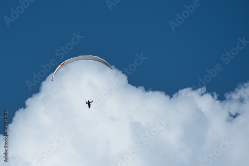 ein gleitschirmflieger surft auf einer wolke, paraglider surfing on a cloud photo