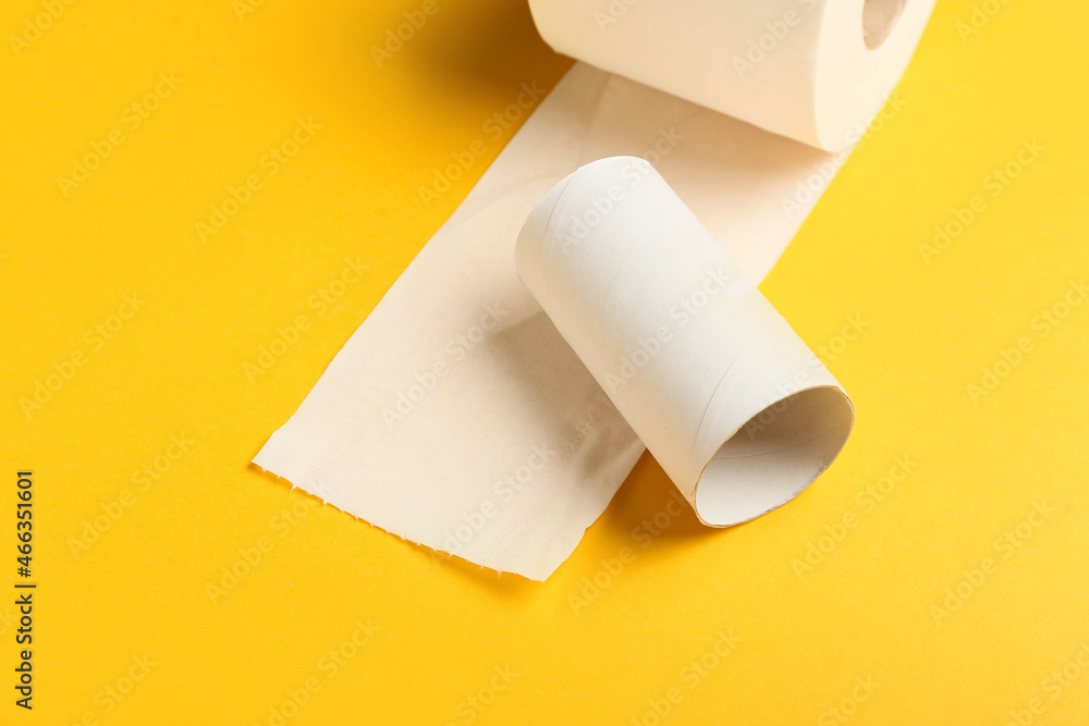 Roll of toilet paper and empty cardboard tube on yellow background, closeup Roll of toilet paper and empty cardboard tube on yellow background, closeup