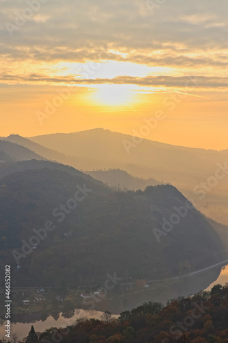 sunrise over mountains rolling landscape with autumn fog over the river