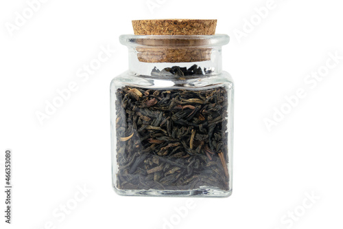 yunnan black tea in a glass jar isolated on white background.