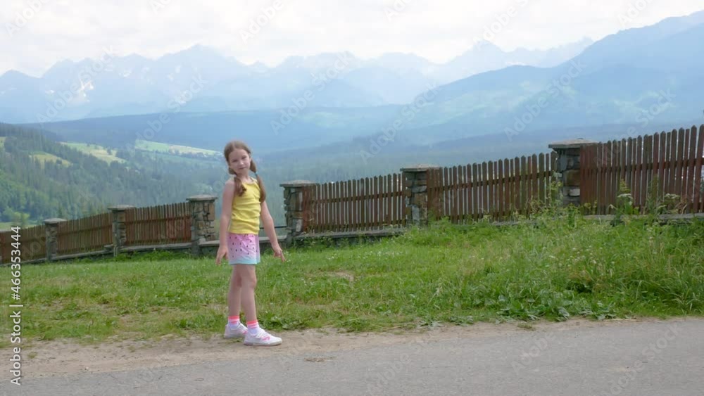 Little happy girl, young cheerful school age child on vacations, holidays, Tatra Polish mountains panorama, Europe Poland travel destinations concept, beautiful Tatras landscape, children travelling Little happy girl, young cheerful school age child on vacations, holidays, Tatra Polish mountains panorama, Europe Poland travel destinations concept, beautiful Tatras landscape, children travelling