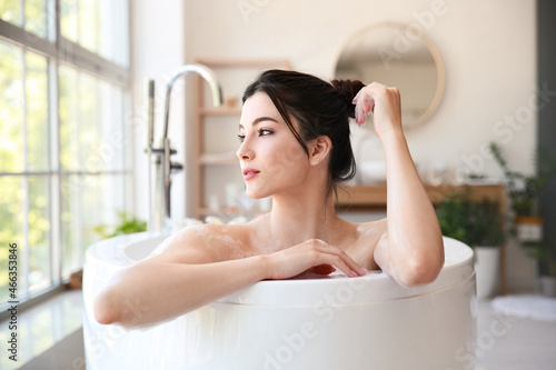 Pretty young woman taking b...
