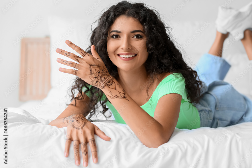 Beautiful Indian woman with henna tattoo at home Beautiful Indian woman with henna tattoo at home