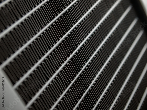 radiator device for heat dissipation in the air by radiation and convection, air heat exchanger, grid close-up, macro, radiator cooling system to protect against overheating of parts