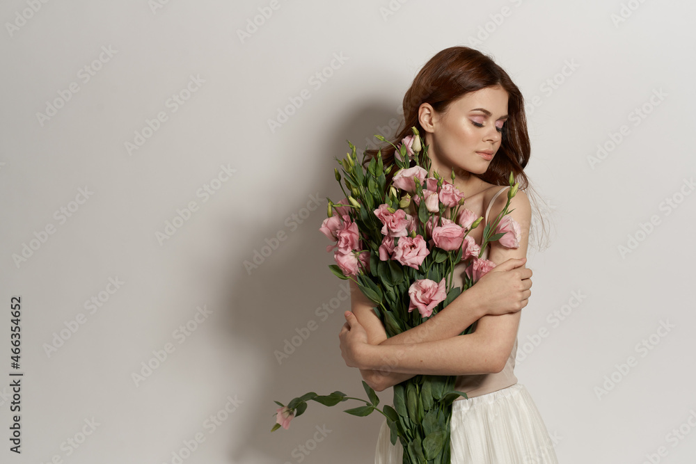 beautiful woman flowers in hands posing charm light background beautiful woman flowers in hands posing charm light background