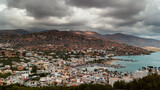 Stormy clouds and bands of rain over the Greek tourist resort town of Elounda on the island of Crete