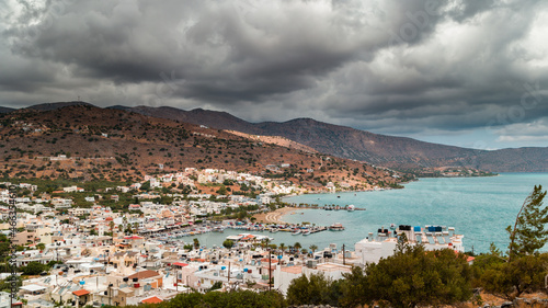 Stormy clouds and bands of rain over the Greek tourist resort town of Elounda on the island of Crete