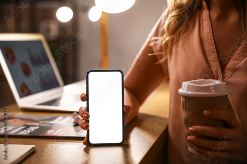 Woman holding modern mobile...
