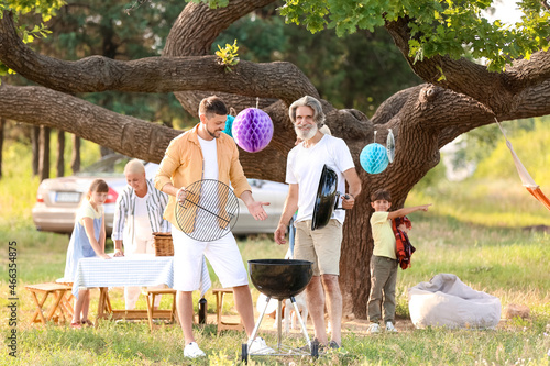 Happy family at barbecue pa...