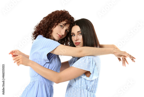 Beautiful young sisters hug...