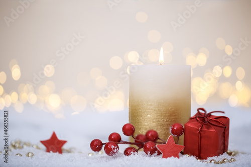 Christmas or new year candle with festive ornaments