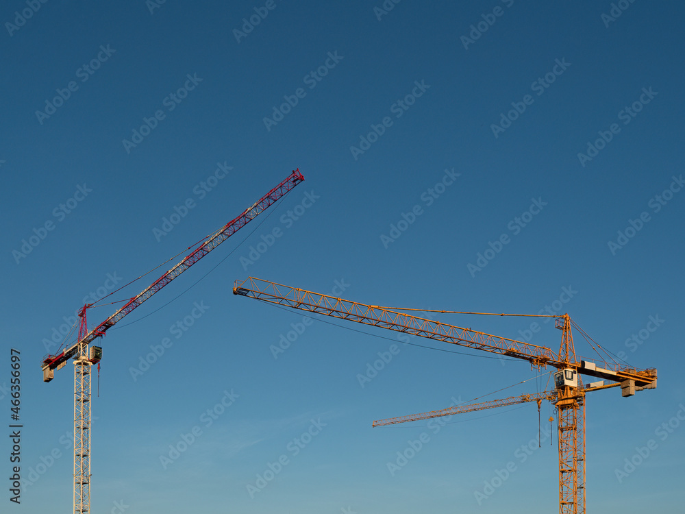Construction crane on a construction site used for the construction of residential houses Construction crane on a construction site used for the construction of residential houses