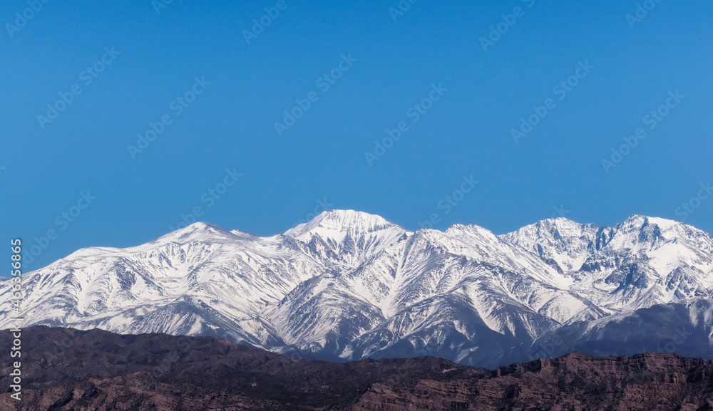 Snowy Andes mountains, as seen from Potrerillos, Mendoza, Argentina, in a sunny, bright winter day.