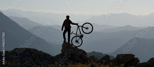 silhouette of a person on a mountain top photo