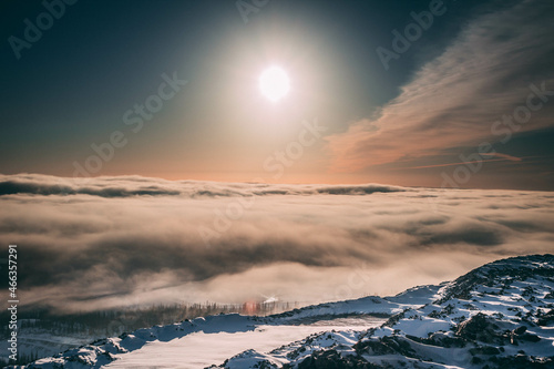 Dawn on a mountain under the clouds in the north in winter 