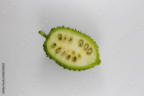 Sliced Spiny gourd or kakrol green vegetable isolated on white background photo