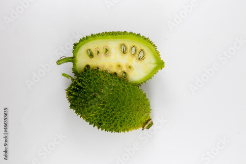 Whole and Sliced Spiny gourd or kakrol green vegetable isolated on white background photo