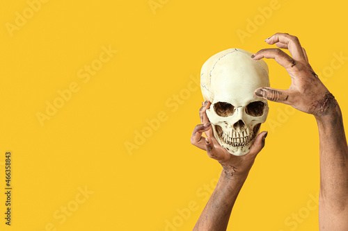 Hands of zombie with skull ...