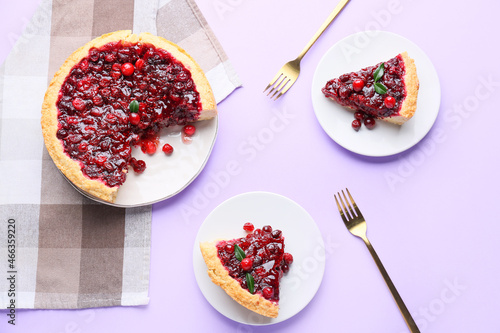 Bilde på lerret Plates with delicious lingonberry pie on color background