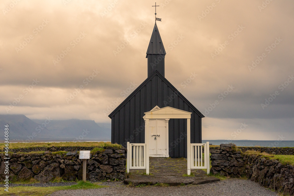 Budir Church in the Snaefelsness Peninsula area of Iceland. Black and white church in dramatic setting. Copy space in sky.