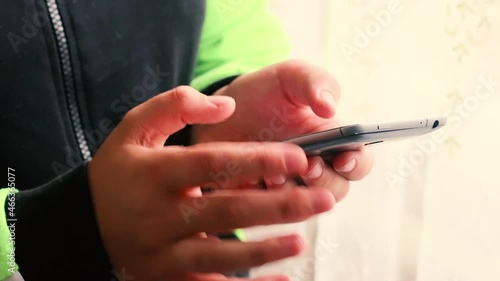 Girl using smartphone close up sliding screen, pressing with finger, surfing internet, social media, shopping online, typing text. Chatting, communicating and pay via mobile phone in two hands