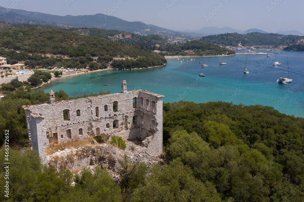 Aerial shot of derelict house on mountain by the beach of Valtos in Parga Greece