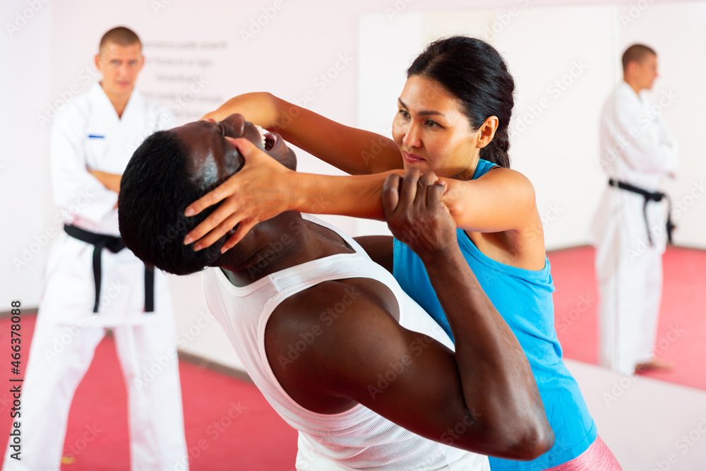 Self-defense lesson - woman strikes painful blow in the eyes of man