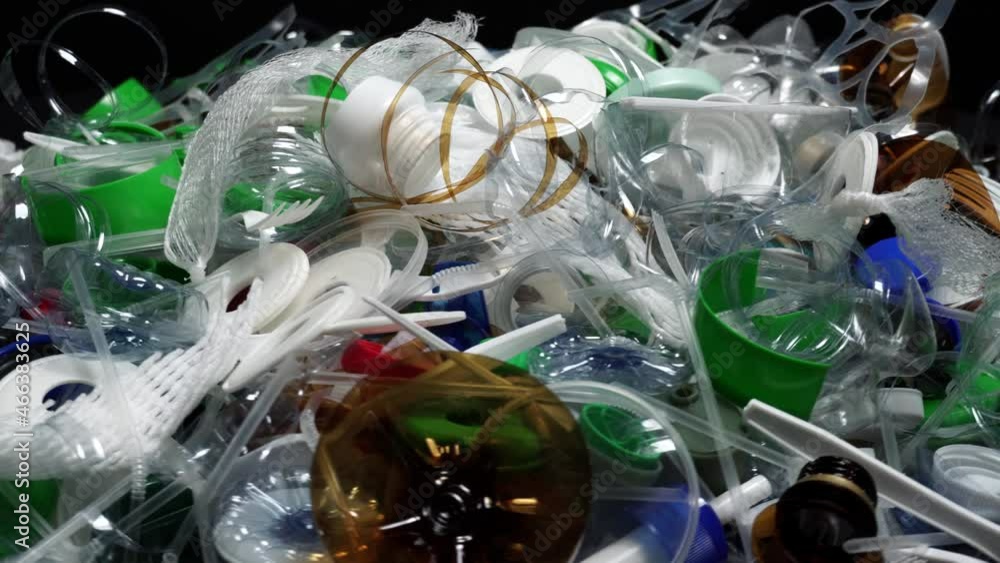 Plastic bottles parts, cups, corks, straws, water and shampoo bottles, creams packaging and other one-time use garbage dumped on the table. Environmental pollution, recycle, waste management problem. Plastic bottles parts, cups, corks, straws, water and shampoo bottles, creams packaging and other one-time use garbage dumped on the table. Environmental pollution, recycle, waste management problem.