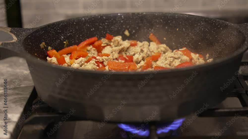 Steam rising from sausage and red peppers cooking on a stove. Steam rising from sausage and red peppers cooking on a stove.