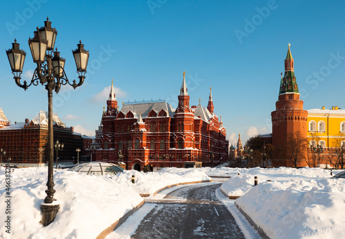 View of State Historical Museum and Kremlin towers from Manezhnaya Square on sunny winter day, Moscow, Russia