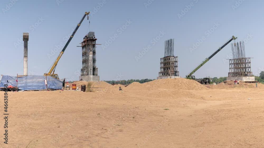 Placing steel girder on the pier column on a sandbank in the Mekong River ( bridge construction ) Placing steel girder on the pier column on a sandbank in the Mekong River ( bridge construction )