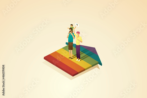 Gay parents stand on a rainbow house.