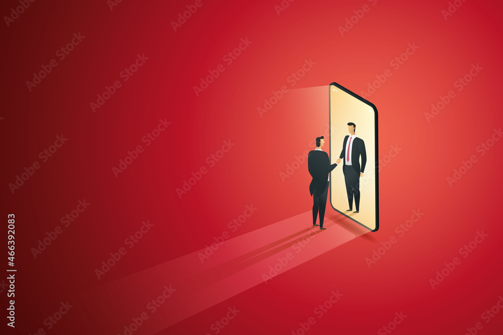 Businessmen shaking hands through a smartphone screen. Businessmen shaking hands through a smartphone screen.