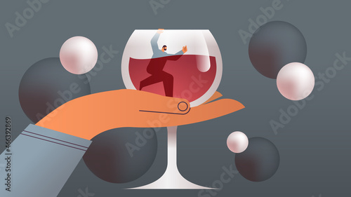 alcoholic man trapped in glass with wine alcohol addiction concept horizontal