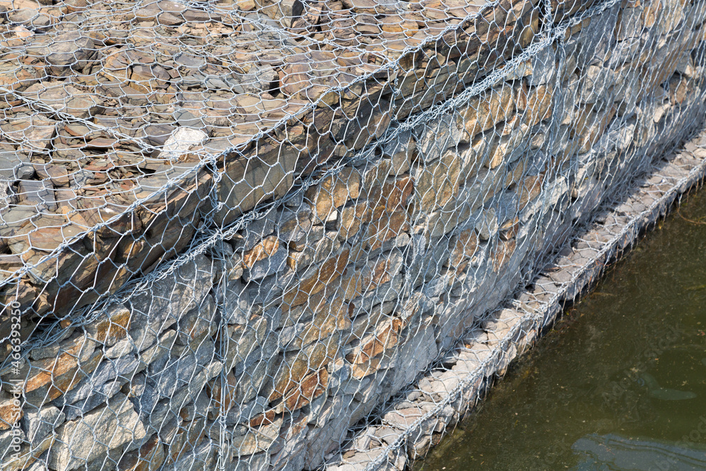 Strengthening the river bank from water blurring in the video of stones in a metal mesh. Strengthening the river bank from water blurring in the video of stones in a metal mesh.