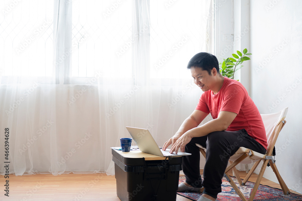 Handsome young man using laptop computer at home. Handsome young man using laptop computer at home.
