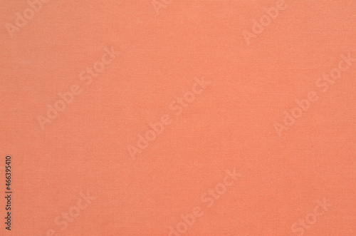 Natural coral-dyed fabric texture background. Close-up of soft cloth backdrop.