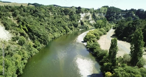 Aerial over lush vegetation and the cooling green Rangitikei river in Summer photo