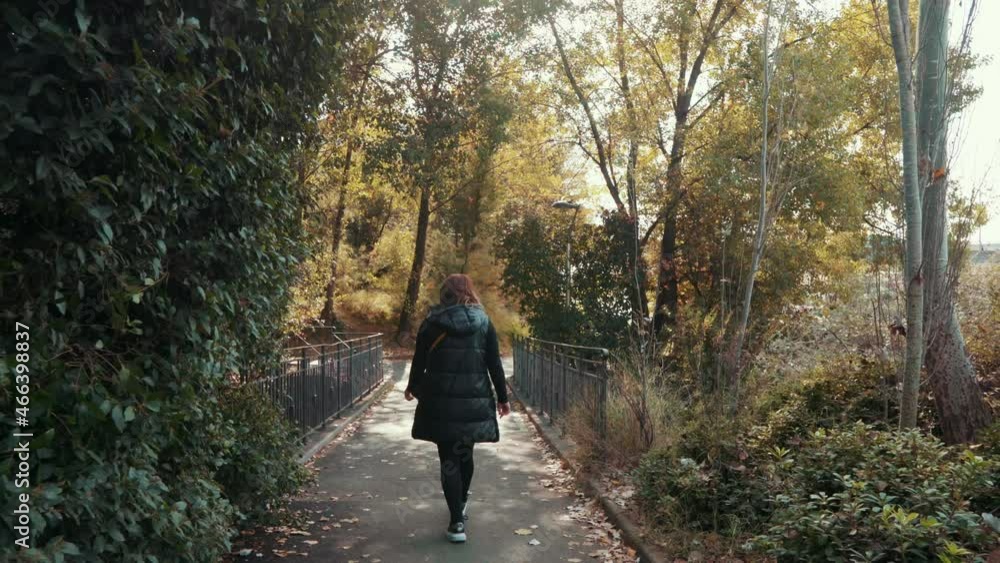 a girl is walking in the park early in the morning, Montpellier - France a girl is walking in the park early in the morning, Montpellier - France