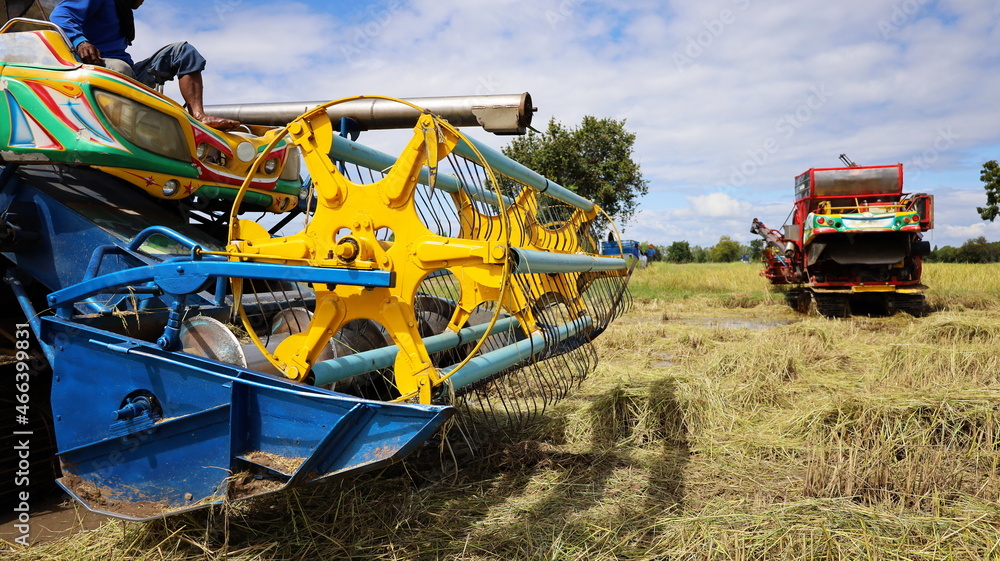 Fototapeta premium Close-up Rotary Harvester. Rotary rotator for harvesting agricultural crops on the ground combine harvesters working in the fields. Selective focus